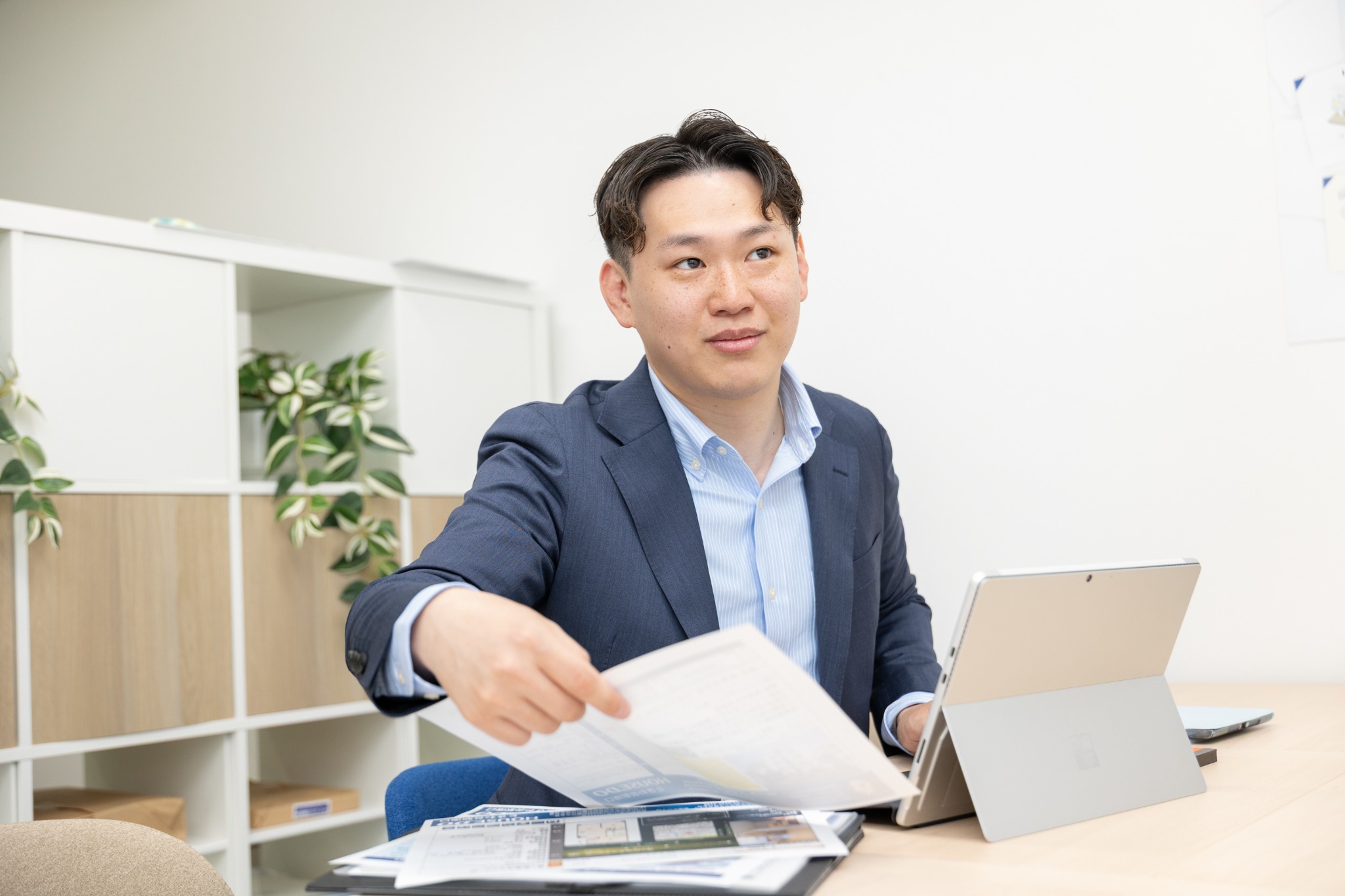 Yoshiaki Tokunaga discussing property documents at Asiascape’s office